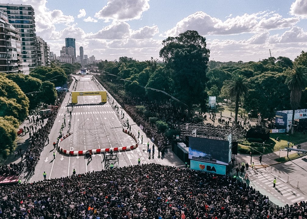 Vista aérea del Colapinto Road Show — pista con arco Mercado Libre, pantalla LED Prina y multitud